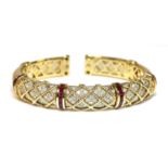 A ruby and diamond sprung torque bangle,