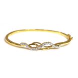 A high carat gold diamond set hinged bangle,