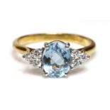 A gold aquamarine and diamond ring,