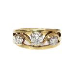 An 18ct gold three stone diamond band ring,