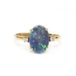 A three stone black opal and diamond ring,