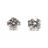 A pair of white gold single stone diamond stud earrings,