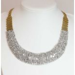 A two colour gold diamond set bib necklace with a graduated centrepiece,