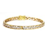 An 18ct gold diamond set hinged bangle,