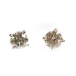 A pair of single stone diamond stud earrings,