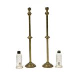 A pair of brass floor standing storm lanterns,