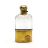 A late Victorian silver-gilt and clear glass hip flask