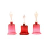 A near pair of large cranberry glass bells,