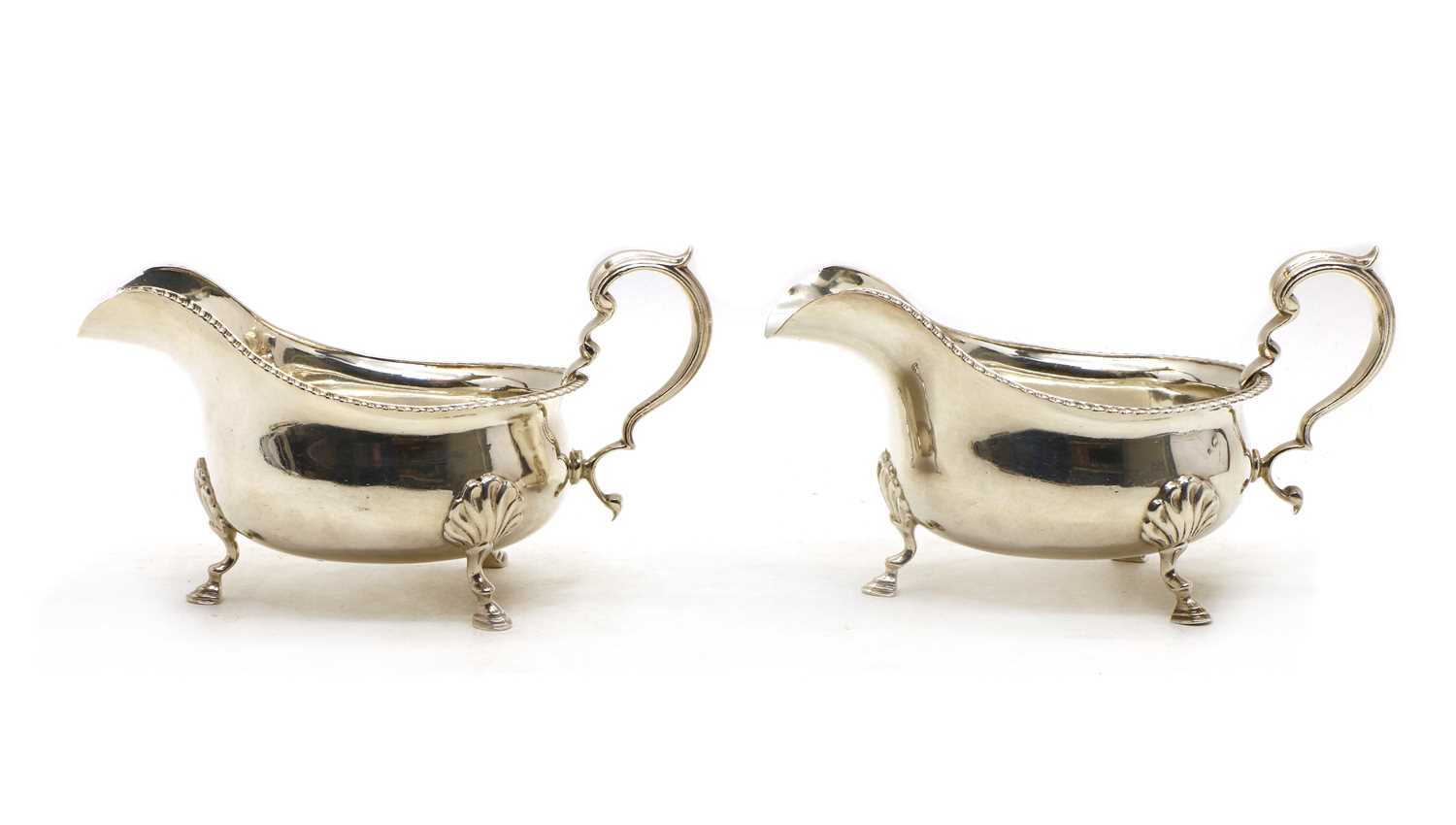 A pair of silver sauceboats