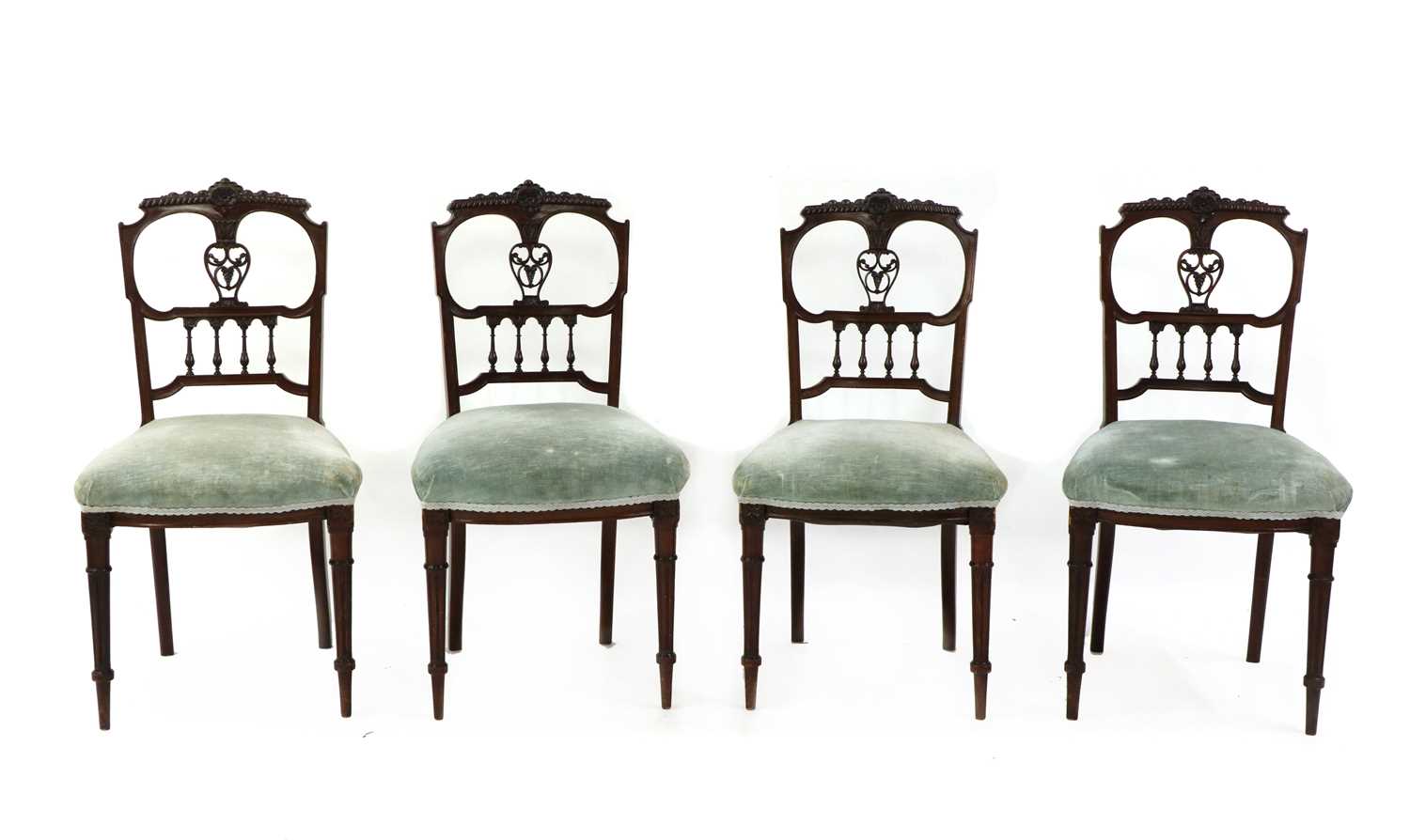 A set of four Edwardian walnut dining chairs,