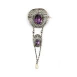 A silver Arts and Crafts amethyst and dog tooth pearl brooch, c.1910,