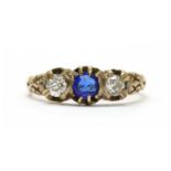 A gold garnet-and-glass doublet and diamond three stone ring,