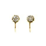 A pair of gold single diamond earrings,