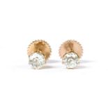 A pair of gold single stone diamond stud earrings,