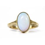 A gold single stone opal ring,