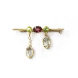 An Edwardian gold aquamarine, garnet and peridot brooch,