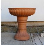 A terracotta coloured stoneware garden planter,