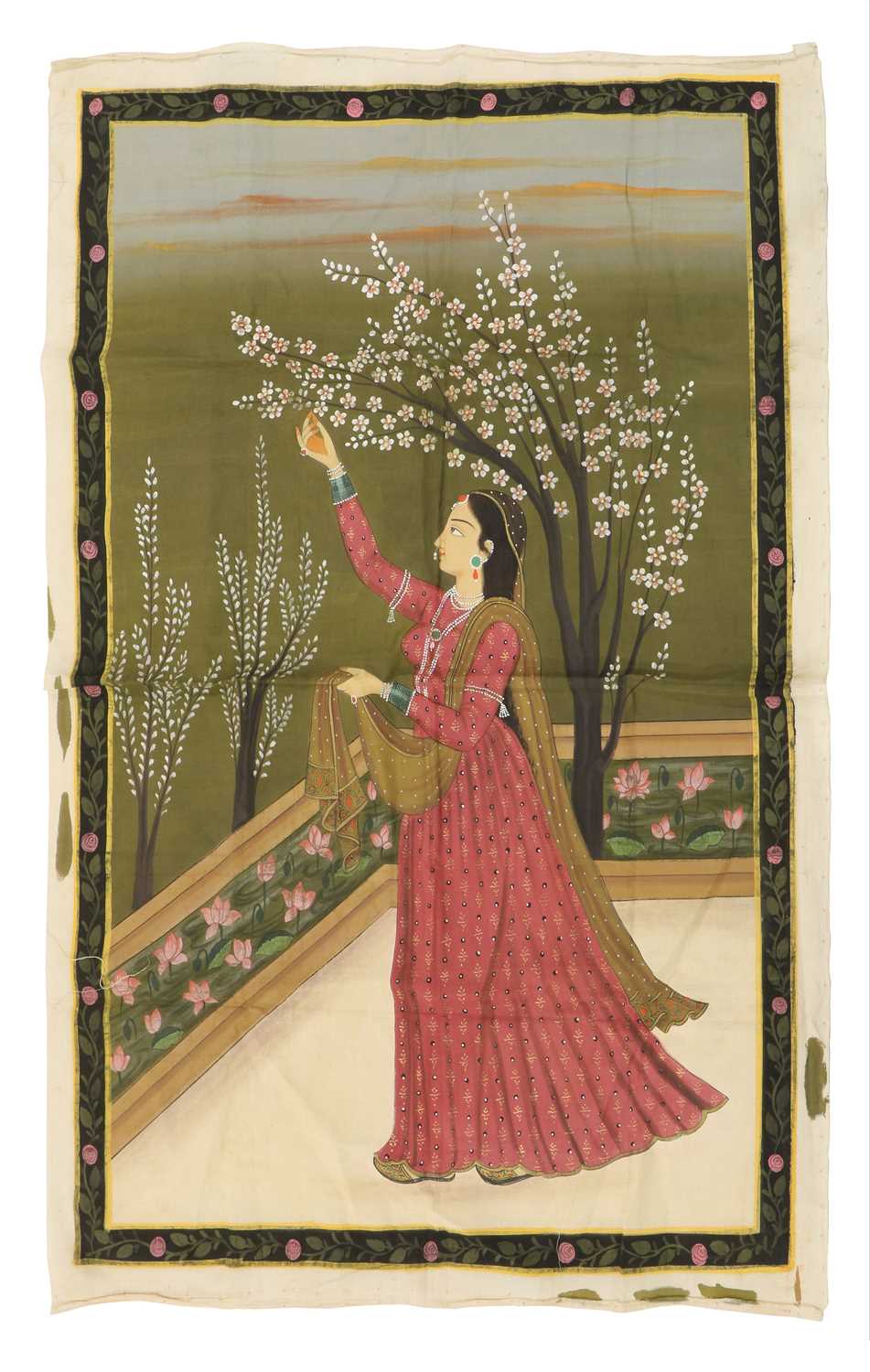 An Indian painting on silk depicting a woman in flowering mauve gown,
