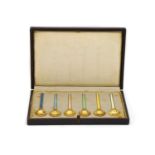 A set of six silver gilt and enamel coffee spoons,