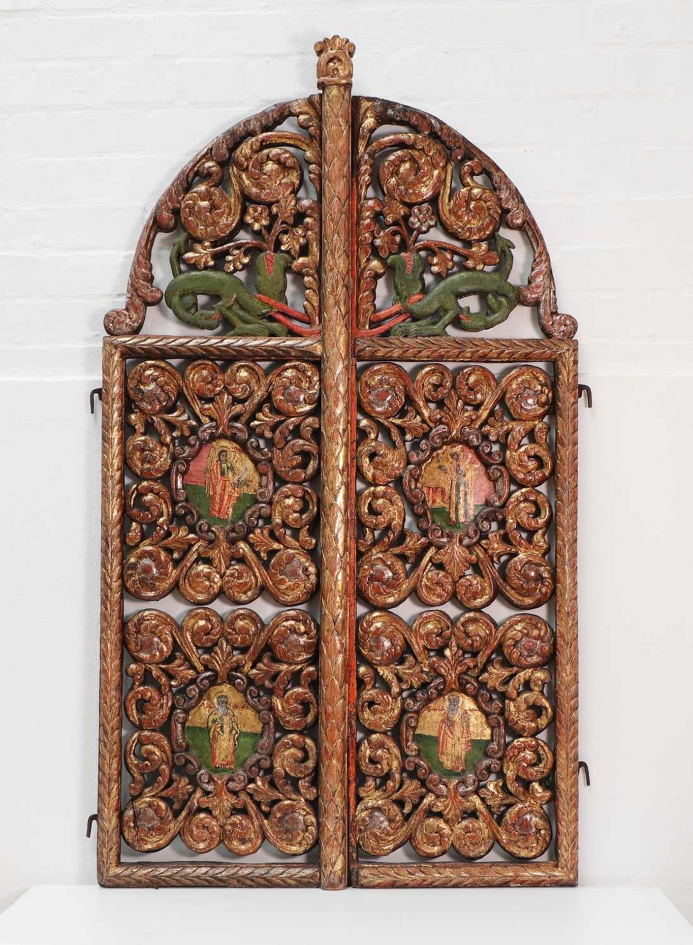 A pair of carved and pierced giltwood royal doors,