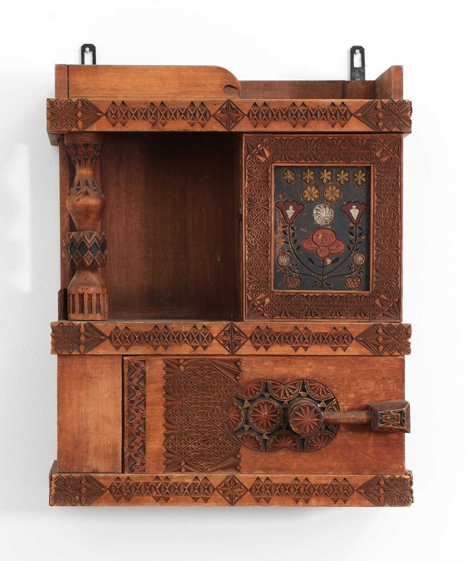 A chip-carved wooden wall-hanging cabinet,
