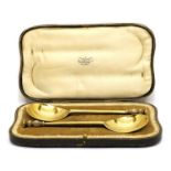 A cased pair of silver gilt seal top spoons,