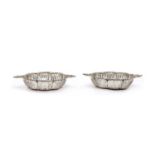 A pair of pierced twin handled silver bon bon dishes,