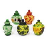 A collection of five Chinese overlay Peking glass jars and covers,