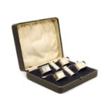 A cased Art Deco silver six piece cruet set
