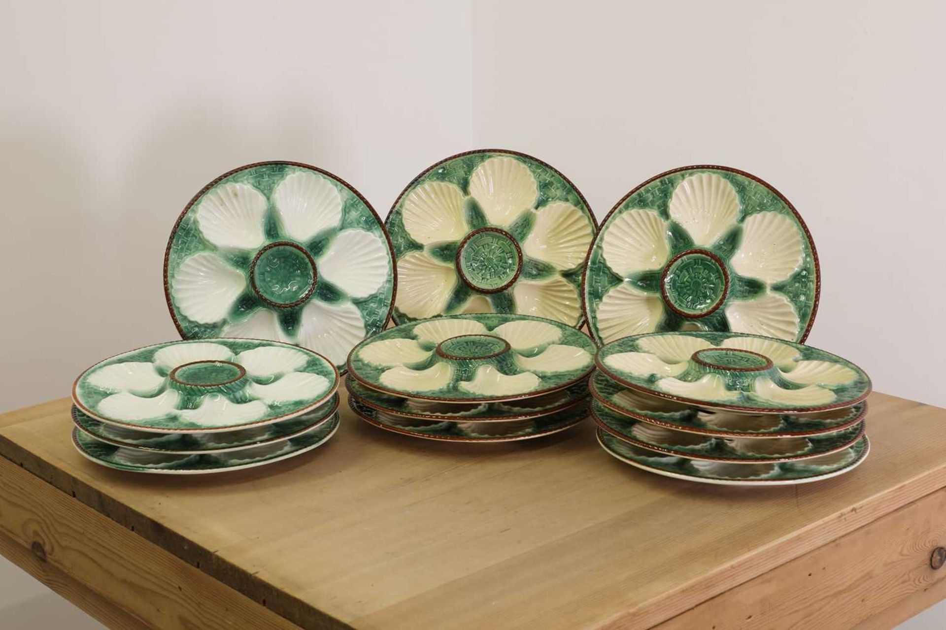 A set of sixteen Longchamp majolica oyster plates,