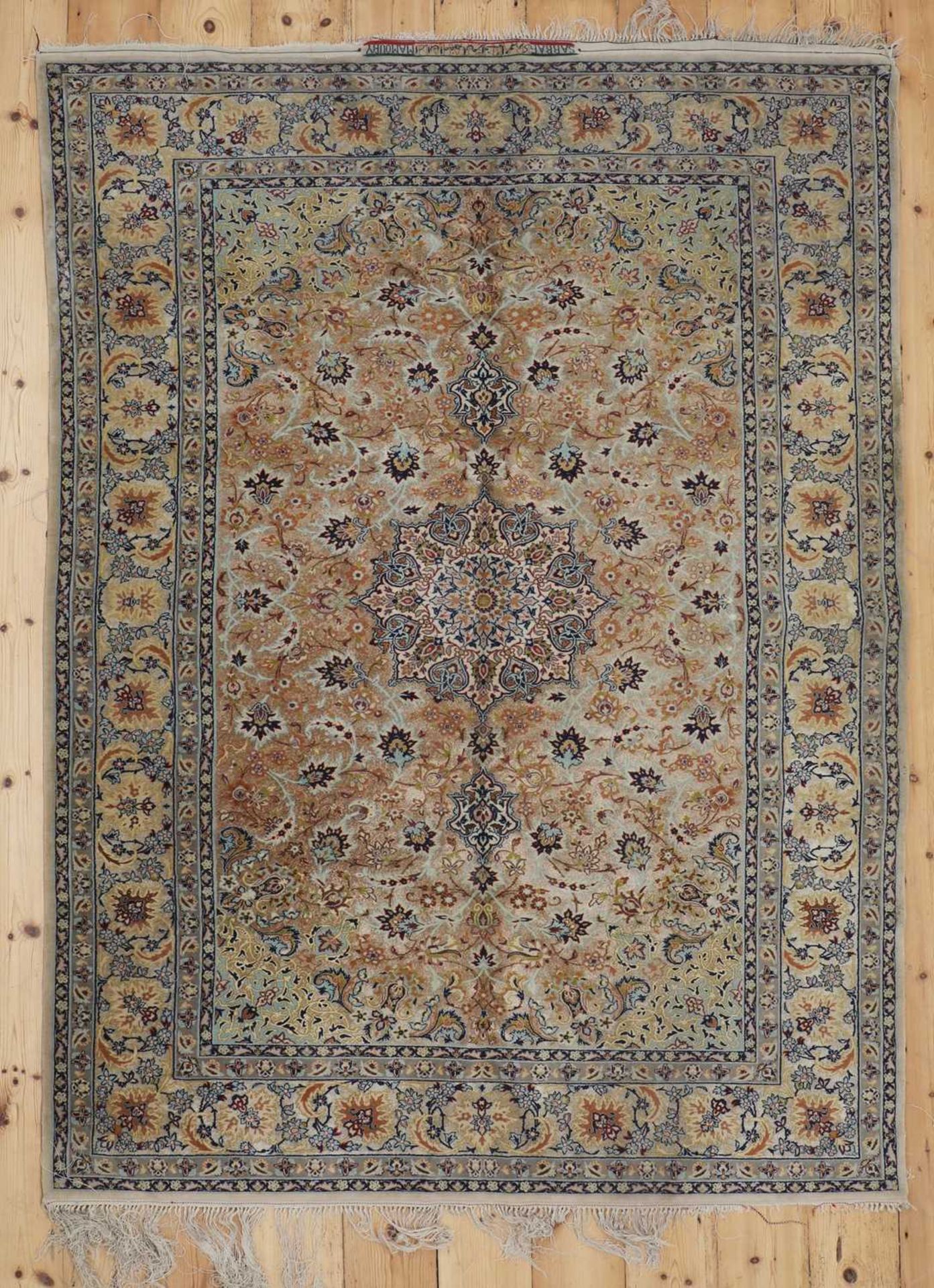 A Persian silk rug,