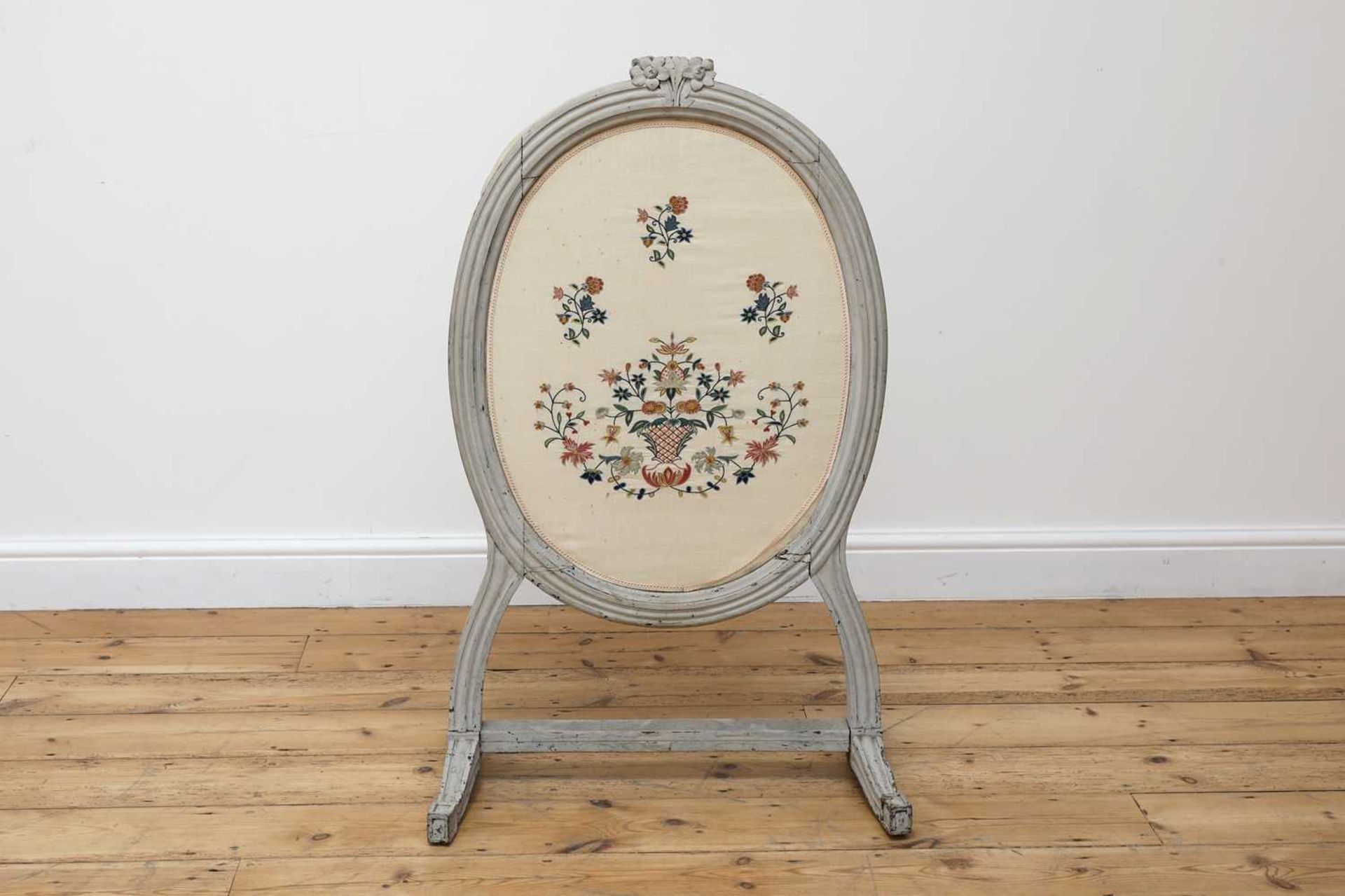 A grey-painted and needlework fire screen,