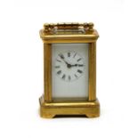 A brass miniature carriage clock