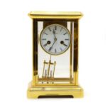 A modern brass four glass mantel clock