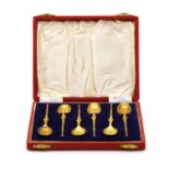 A cased set of six silver gilt anointing spoons,