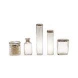 Five silver lidded cut glass dressing table jars