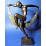 A figure of a female dancer; patinated bronze and in the Art Deco style (approx 23.7cm high)