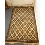 A heavy hand-knotted woollen rug; various repeating stylised patterns against a predominantly