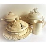 A selection of modern kitchen creamware to include lidded tureens and platters