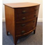 An early 19th century bow-fronted mahogany commode; hinged top and with large, full-width bow-
