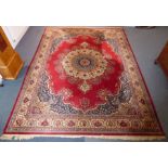 A large and fine Persian-style carpet; the central multi-coloured mon with Moorish-style palmettes
