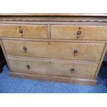 An early 20th century oak chest; moulded top above two half-width and two full-width drawers, raised