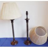 A pair of fluted bronze lamps with shades