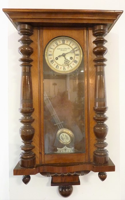 A late 19th century walnut-cased wall-hanging regulator-style clock; the white-enamel dial signed '