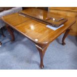 A large early 20th century extending mahogany dining table having two extra leaves; moulded top