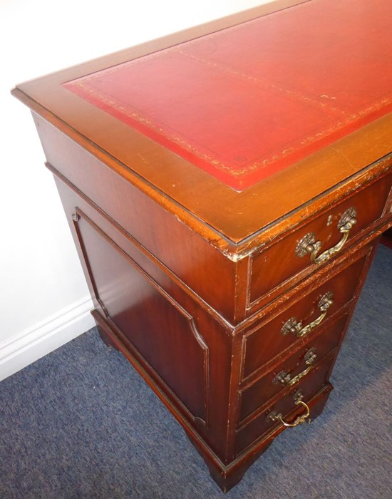 A reproduction mahogany Georgian-style pedestal desk; red-leather-inset top above an arrangement - Image 6 of 6