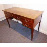 An Edwardian period mahogany and satinwood cross-banded writing table; two half-width drawers