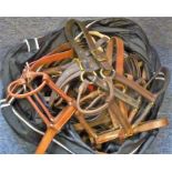 A bag of tack to include fabric lead rope, leather girths, miscellaneous brow bands, leather head
