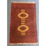 A small hand-knotted red ground Bokhara-style rug (100cm x 63cm)