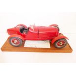 A hand-built plastic model of an Alfa-Romeo open-top racing car together with instructions etc. on a